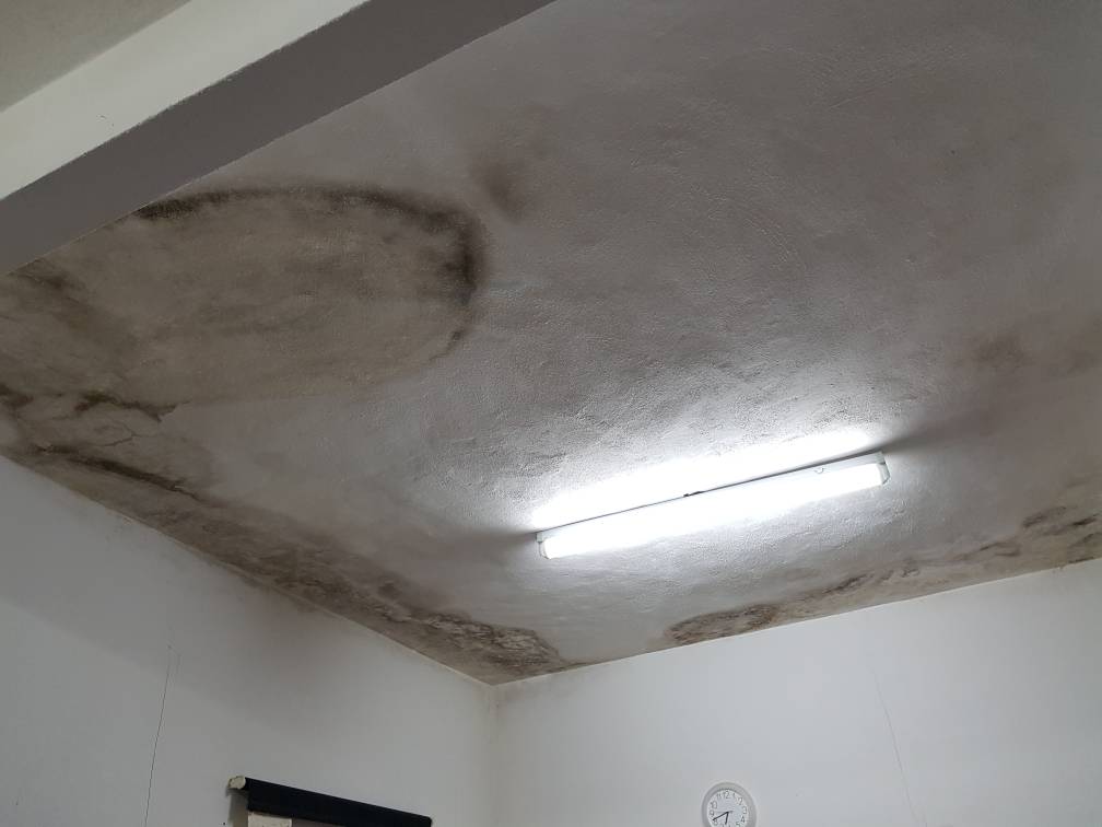 HDB bathroom ceiling water stain before repair in Tampines